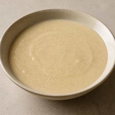 Smooth Oat and Banana Porridge with Milk. Rolled oats simmered well past the usual point and then blended with ripe banana, milk powder and a knob of butter into a pourable porridge with no grain left in it.